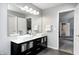 This bathroom features double sinks, a framed mirror, and a doorway leading to another room at 10717 Windermere Blvd, Fishers, IN 46037