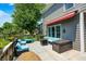 Outdoor wooden deck featuring a fire pit, comfortable seating, and a retractable awning at 10717 Windermere Blvd, Fishers, IN 46037