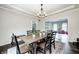 Cozy dining room with a wooden table, chairs, chandelier, and decorative rug, adjacent to the kitchen and living area at 10717 Windermere Blvd, Fishers, IN 46037