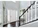 Elegant foyer features hardwood floors, high ceilings, and a staircase with white railings at 10717 Windermere Blvd, Fishers, IN 46037