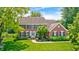 Charming brick home with meticulously landscaped front yard and a welcoming entrance at 10717 Windermere Blvd, Fishers, IN 46037