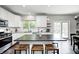 Spacious kitchen with white cabinetry, granite countertops, stainless steel appliances, and an island with barstool seating at 10717 Windermere Blvd, Fishers, IN 46037