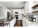 Bright, updated kitchen with stainless steel appliances, granite counters, and a dark island with breakfast bar at 10717 Windermere Blvd, Fishers, IN 46037