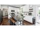 Well-lit kitchen features granite countertops, stainless steel appliances, and a gray island with seating at 10717 Windermere Blvd, Fishers, IN 46037