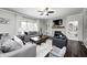 Spacious living room with hardwood floors, comfortable seating, fireplace and ample natural light at 10717 Windermere Blvd, Fishers, IN 46037