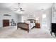 This main bedroom boasts a ceiling fan, bedside tables, and a dresser with desk space at 10717 Windermere Blvd, Fishers, IN 46037