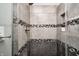 The shower in this bathroom features a tiled wall surround with built in soap and shampoo niche at 10717 Windermere Blvd, Fishers, IN 46037