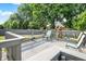 Inviting back deck with chairs overlooks backyard and play set, perfect for outdoor enjoyment at 10902 Jimmy Lake Dr, Indianapolis, IN 46239
