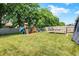Large, fenced backyard featuring a play set, deck, and lush green lawn, great for outdoor fun at 10902 Jimmy Lake Dr, Indianapolis, IN 46239