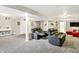 Finished basement featuring neutral colors, gray carpet, and comfortable seating for relaxing and entertaining at 10902 Jimmy Lake Dr, Indianapolis, IN 46239