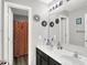 Bright bathroom with a double sink vanity, decorative mirrors, and an open doorway to the shower at 10902 Jimmy Lake Dr, Indianapolis, IN 46239