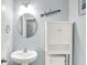 Powder blue bathroom includes a white sink vanity with round mirror and 'Relax' wall decor at 10902 Jimmy Lake Dr, Indianapolis, IN 46239