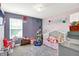 The bedroom is decorated with stuffed animals and a unicorn rocking horse at 10902 Jimmy Lake Dr, Indianapolis, IN 46239