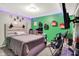 This bedroom features a comfortable bed, workspace, vibrant green wall and LED lighting at 10902 Jimmy Lake Dr, Indianapolis, IN 46239