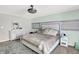 This bedroom features carpet, a king bed, a ceiling fan, and a soft color palette at 10902 Jimmy Lake Dr, Indianapolis, IN 46239