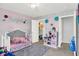 The bedroom is decorated with a play kitchen and pastel colors at 10902 Jimmy Lake Dr, Indianapolis, IN 46239