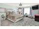 This cozy bedroom features carpet, a king bed, and a sitting area near the window at 10902 Jimmy Lake Dr, Indianapolis, IN 46239
