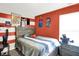 This bedroom features a neutral color scheme with red accents, complete with a bed and side table at 10902 Jimmy Lake Dr, Indianapolis, IN 46239