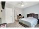 Neutral bedroom with a tufted headboard bed, white walls, and natural light at 10902 Jimmy Lake Dr, Indianapolis, IN 46239