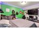 This bedroom features a comfortable bed, workspace, vibrant green wall and LED lighting at 10902 Jimmy Lake Dr, Indianapolis, IN 46239