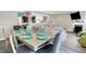 Dining room with decoratively set table, open to living areas, and flooded with natural light at 10902 Jimmy Lake Dr, Indianapolis, IN 46239