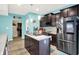 Kitchen featuring a center island with sink, stainless steel appliances, and light wood flooring at 10902 Jimmy Lake Dr, Indianapolis, IN 46239
