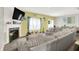 Bright living room featuring a fireplace, neutral sectional sofa, and backyard access at 10902 Jimmy Lake Dr, Indianapolis, IN 46239