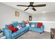 Upstairs living room with a ceiling fan, comfortable blue seating, and natural light at 10902 Jimmy Lake Dr, Indianapolis, IN 46239