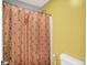 This vibrant bathroom features a shower with a playful orange geometric pattern shower curtain at 10902 Jimmy Lake Dr, Indianapolis, IN 46239