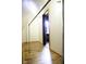 Finished attic space with wood flooring and bright overhead lighting fixtures at 1115 N Kealing Ave, Indianapolis, IN 46201