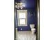 Cozy blue bathroom featuring a window and classic black and white patterned tile flooring at 1115 N Kealing Ave, Indianapolis, IN 46201