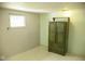 Simple bedroom with a window and wooden closet and dresser for storage at 1115 N Kealing Ave, Indianapolis, IN 46201