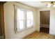 Bright bedroom featuring hardwood floors, closet and double-pane windows at 1115 N Kealing Ave, Indianapolis, IN 46201