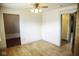 Open bedroom features a ceiling fan, closet and access to another room at 1115 N Kealing Ave, Indianapolis, IN 46201