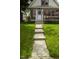 Inviting walkway leading to the front door of a charming home with a lush green lawn at 1115 N Kealing Ave, Indianapolis, IN 46201