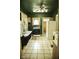 Green kitchen featuring tile floors, an oven, and a large window at 1115 N Kealing Ave, Indianapolis, IN 46201