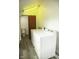 Bright laundry room with a side-by-side washer and dryer, and additional toilet area at 1115 N Kealing Ave, Indianapolis, IN 46201