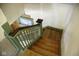 Wooden staircase featuring a stained glass window and a painted banister at 1115 N Kealing Ave, Indianapolis, IN 46201