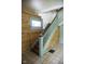 A view of a staircase showing the decorative wood paneling, and stained glass window at 1115 N Kealing Ave, Indianapolis, IN 46201