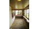 Sun porch featuring large windows, brick accents, and unique flooring at 1115 N Kealing Ave, Indianapolis, IN 46201