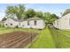 Backyard featuring a grass lawn, garden, and a chain-link fence at 1116 N Berwick Ave, Indianapolis, IN 46222