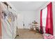 Bedroom with a table, bright window, and ample closet storage at 1116 N Berwick Ave, Indianapolis, IN 46222