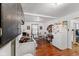 Simple kitchen with white appliances, dark cabinetry, and wood-look flooring at 1116 N Berwick Ave, Indianapolis, IN 46222