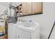Laundry room with a washer, dryer, and overhead cabinets at 1116 N Berwick Ave, Indianapolis, IN 46222