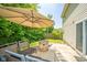 Relaxing backyard patio area with seating, an umbrella, and a stone fire pit, perfect for outdoor entertaining at 1139 Maple Stream Dr, Indianapolis, IN 46217