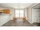 Cozy dining room features wood floors, an elegant chandelier, and a large window for natural light at 1139 Maple Stream Dr, Indianapolis, IN 46217