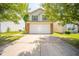 Two-story home featuring an attached garage, a well-manicured lawn, and mature trees for added curb appeal at 1139 Maple Stream Dr, Indianapolis, IN 46217