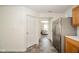 Hallway view with a glimpse into a living area with a large stainless steel refrigerator at 1139 Maple Stream Dr, Indianapolis, IN 46217