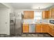Bright kitchen with stainless steel appliances, wooden cabinets, and light countertops at 1139 Maple Stream Dr, Indianapolis, IN 46217
