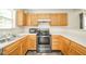 Modern kitchen with stainless steel appliances, wooden cabinets, and white countertops at 1139 Maple Stream Dr, Indianapolis, IN 46217